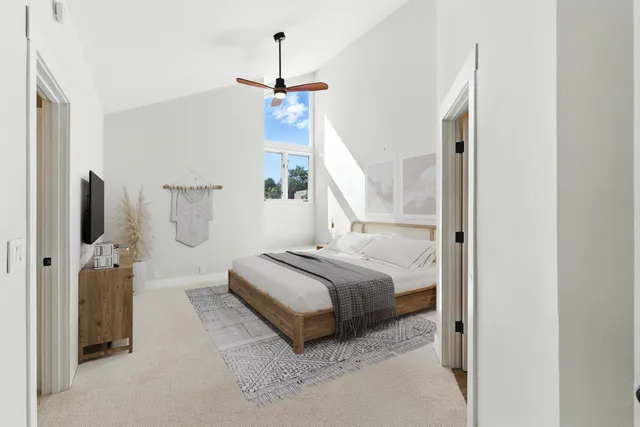 a spacious bedroom with a bed and a window