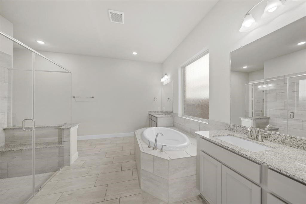 31302 Quartet Court Fulshear, TX 77441 - Photo 19 of 32 a bathroom with a granite countertop sink mirror and toilet
