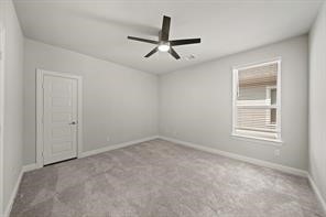 31302 Quartet Court Fulshear, TX 77441 - Photo 25 of 32 an empty room with ceiling fan and window