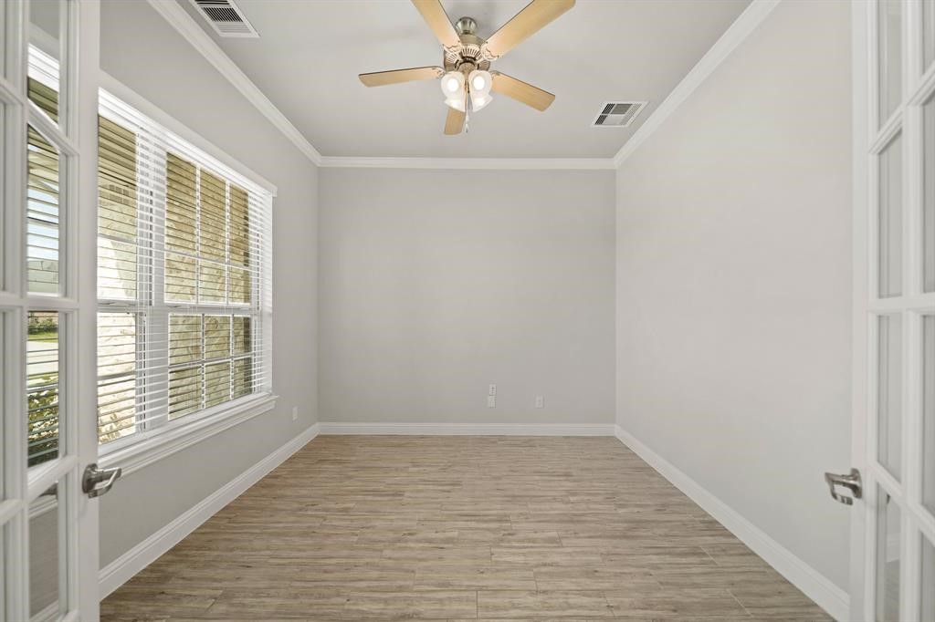 31302 Quartet Court Fulshear, TX 77441 - Photo 6 of 32 a view of an empty room with a window and a kitchen view