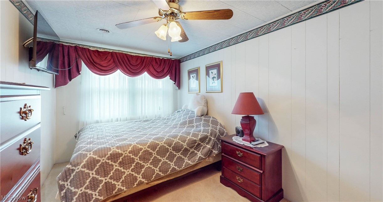 466 Pine Lake Road Sebring, OH 44672 - Photo 22 of 30 Carpeted bedroom with ceiling fan
