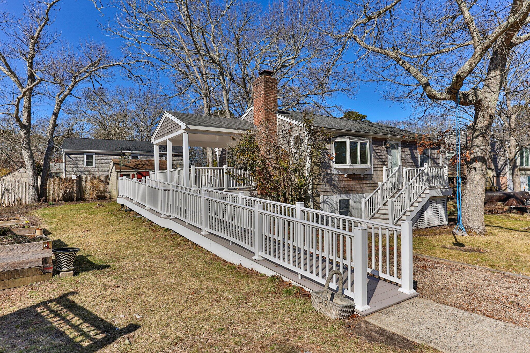 5 Signe Road Dennis, MA 02638 - Photo 1 of 39 a view of a house with wooden fence in front of it