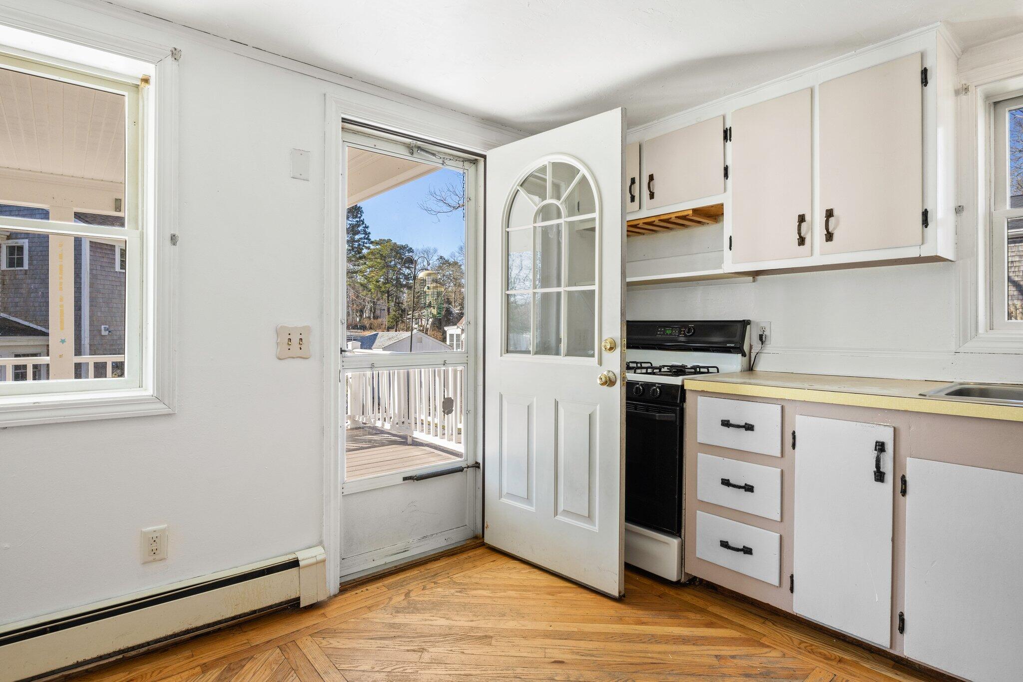 5 Signe Road Dennis, MA 02638 - Photo 12 of 39 a kitchen with cabinets and wooden floor