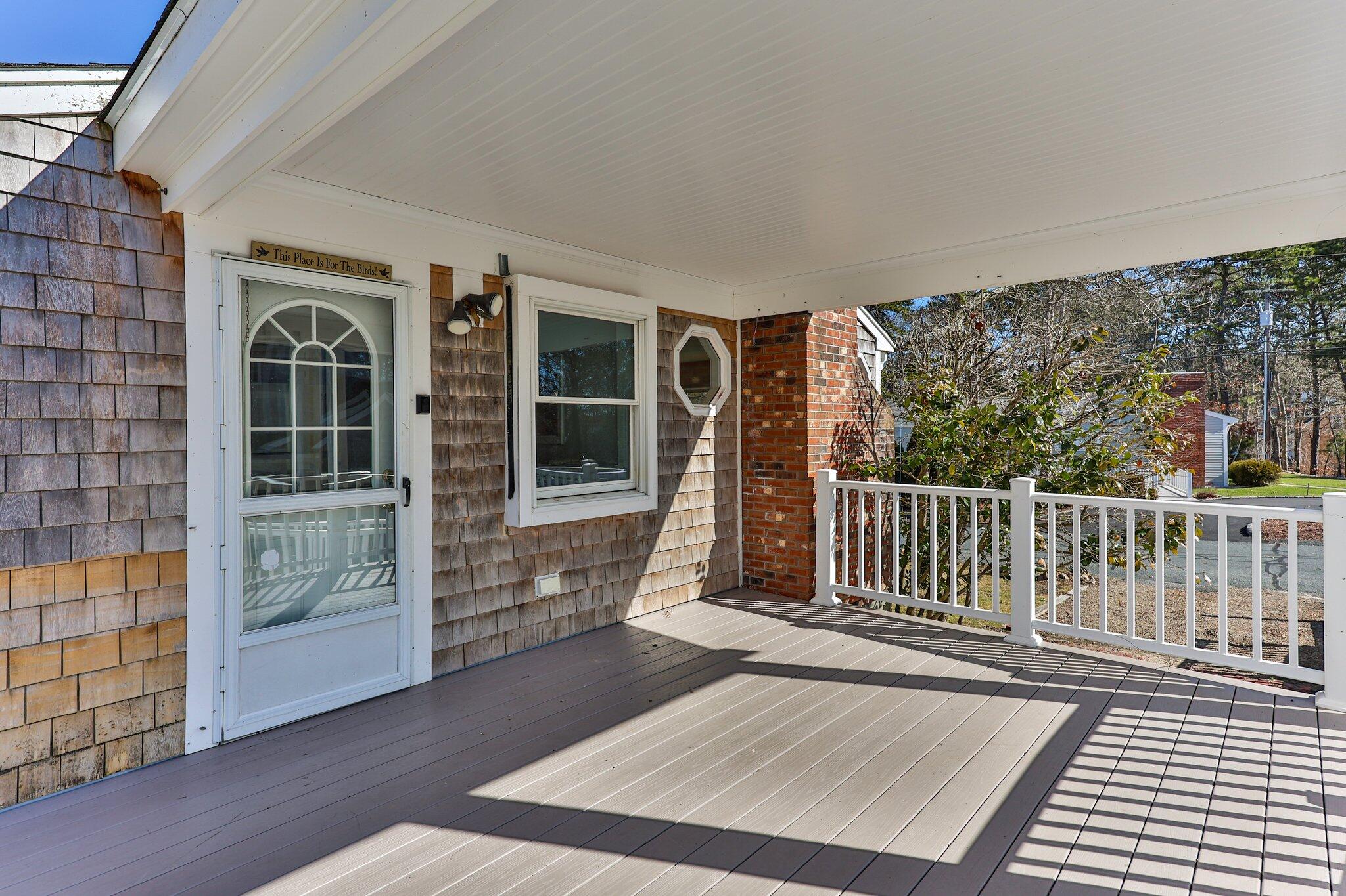 5 Signe Road Dennis, MA 02638 - Photo 13 of 39 a porch with a bench in front of it