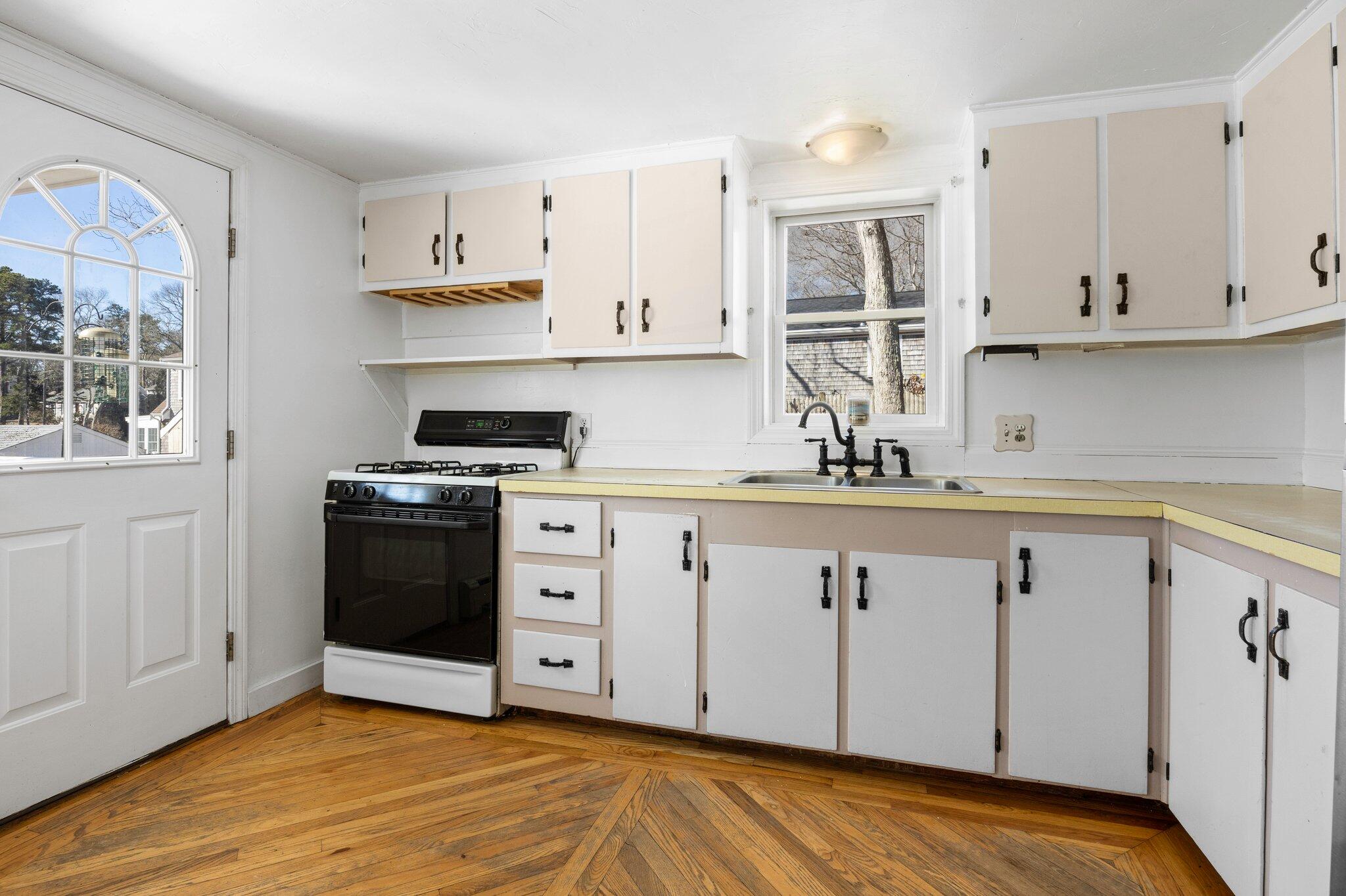 5 Signe Road Dennis, MA 02638 - Photo 15 of 39 a kitchen with granite countertop white cabinets and stainless steel appliances
