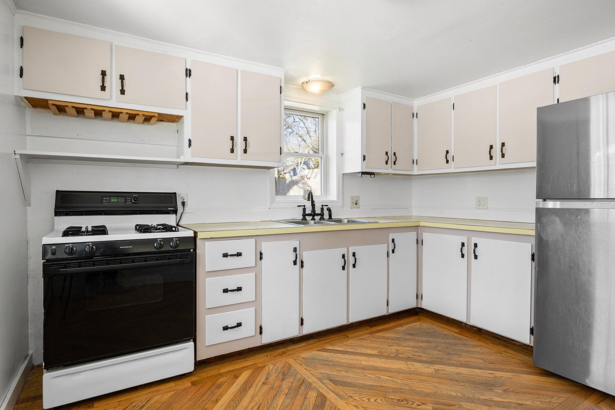 5 Signe Road Dennis, MA 02638 - Photo 16 of 39 a kitchen with white cabinets white stainless steel appliances and sink