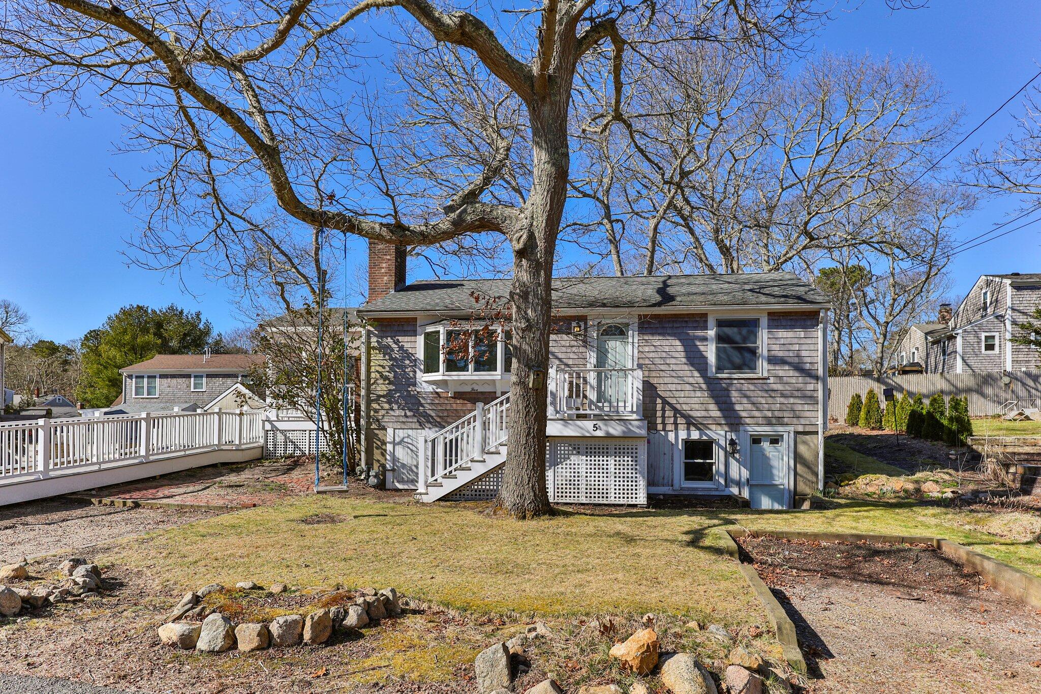 5 Signe Road Dennis, MA 02638 - Photo 4 of 39 a front view of a house with a yard