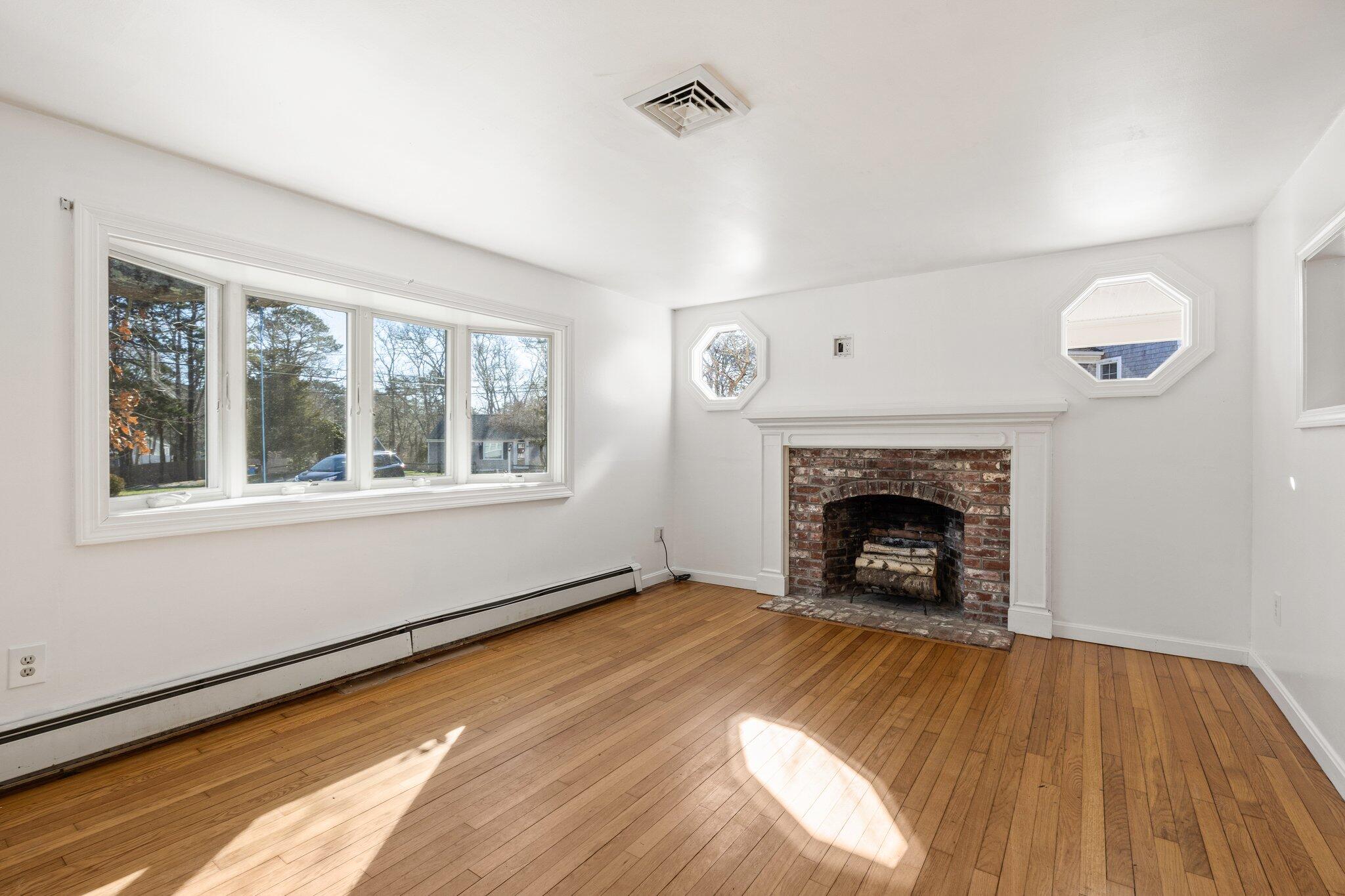 5 Signe Road Dennis, MA 02638 - Photo 8 of 39 a view of an empty room with wooden floor and a window