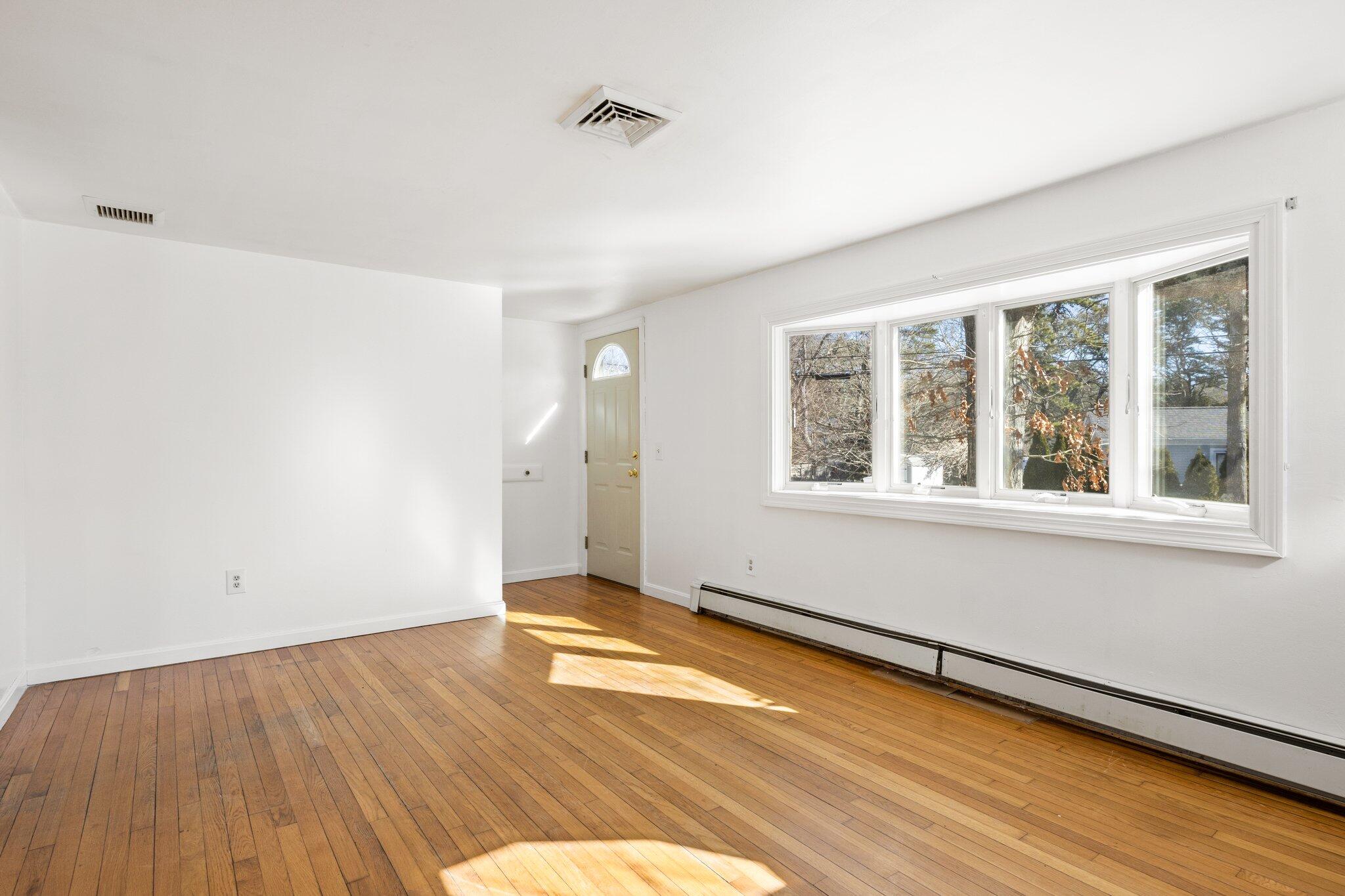 5 Signe Road Dennis, MA 02638 - Photo 9 of 39 a view of an empty room with wooden floor and a window