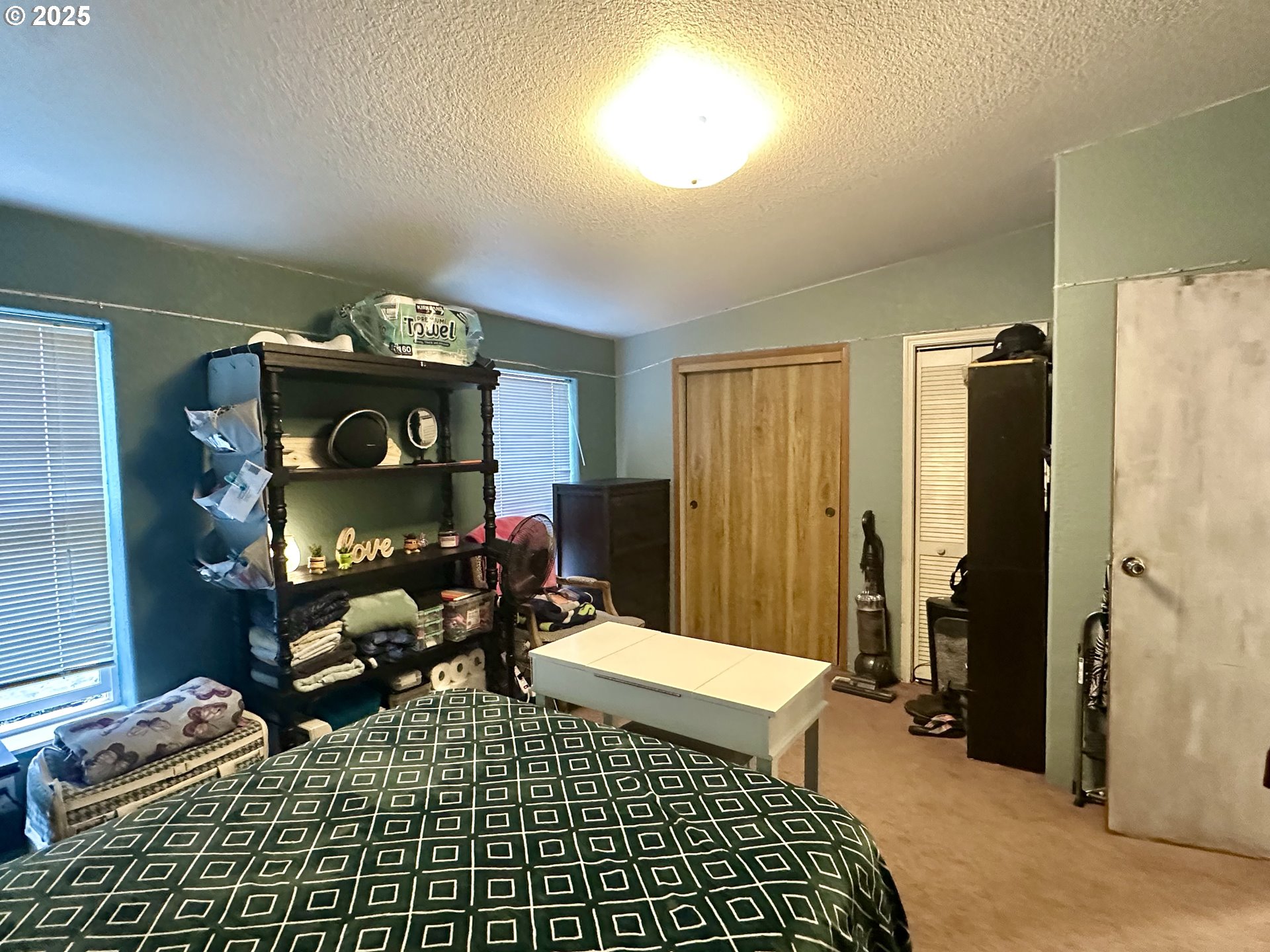 5510 E Street Springfield, OR 97478 - Photo 15 of 21 a bedroom with a bed and a chandelier
