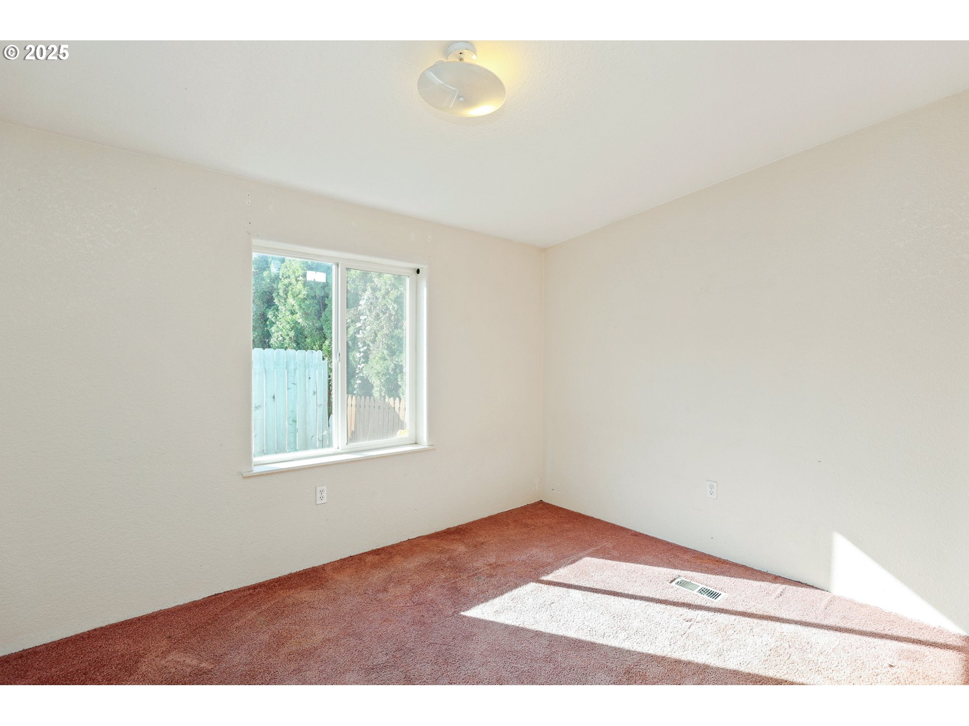 5510 E Street Springfield, OR 97478 - Photo 16 of 21 a view of an empty room with wooden floor and a window