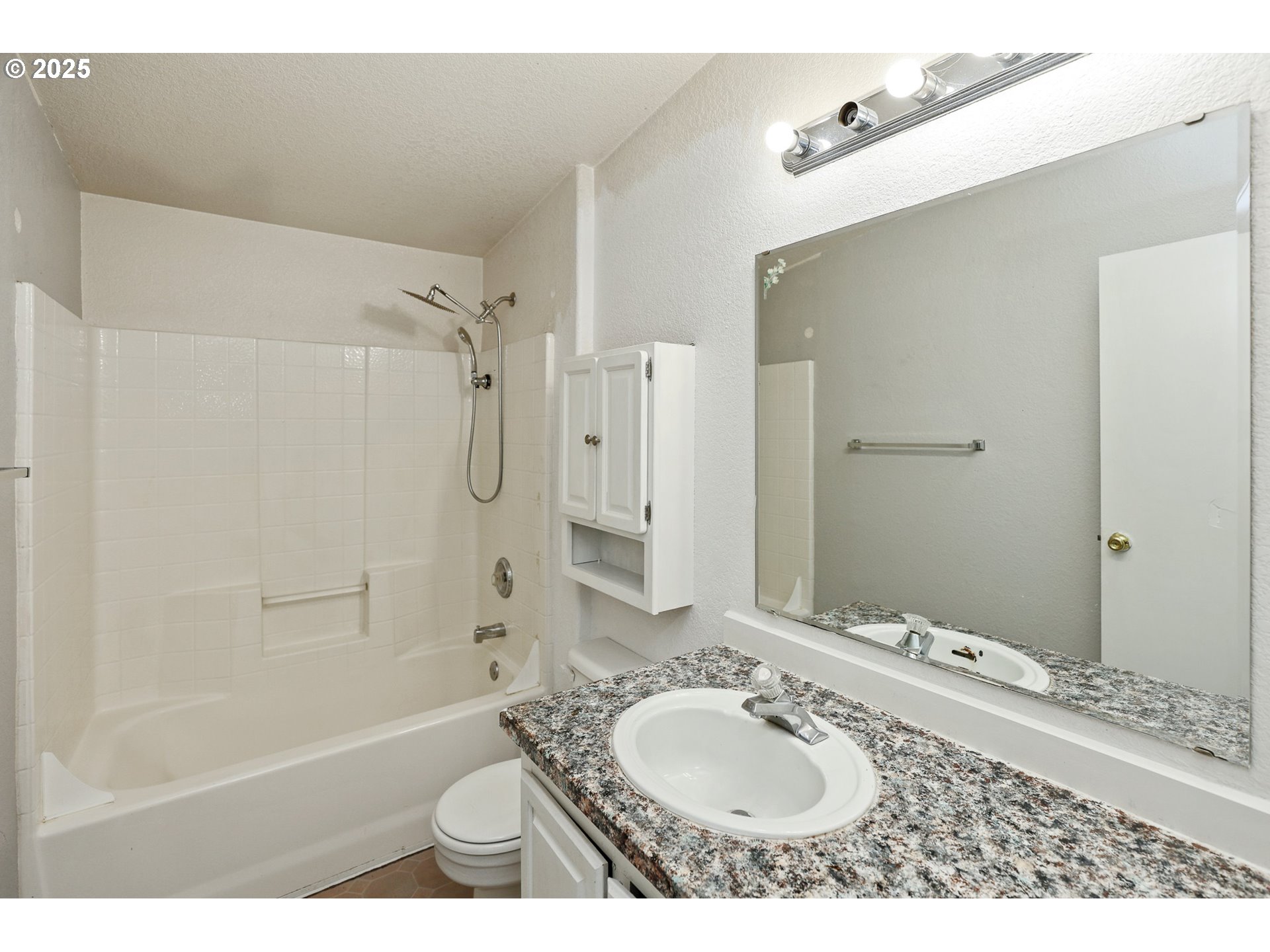 5510 E Street Springfield, OR 97478 - Photo 19 of 21 a bathroom with a granite countertop sink toilet mirror and shower