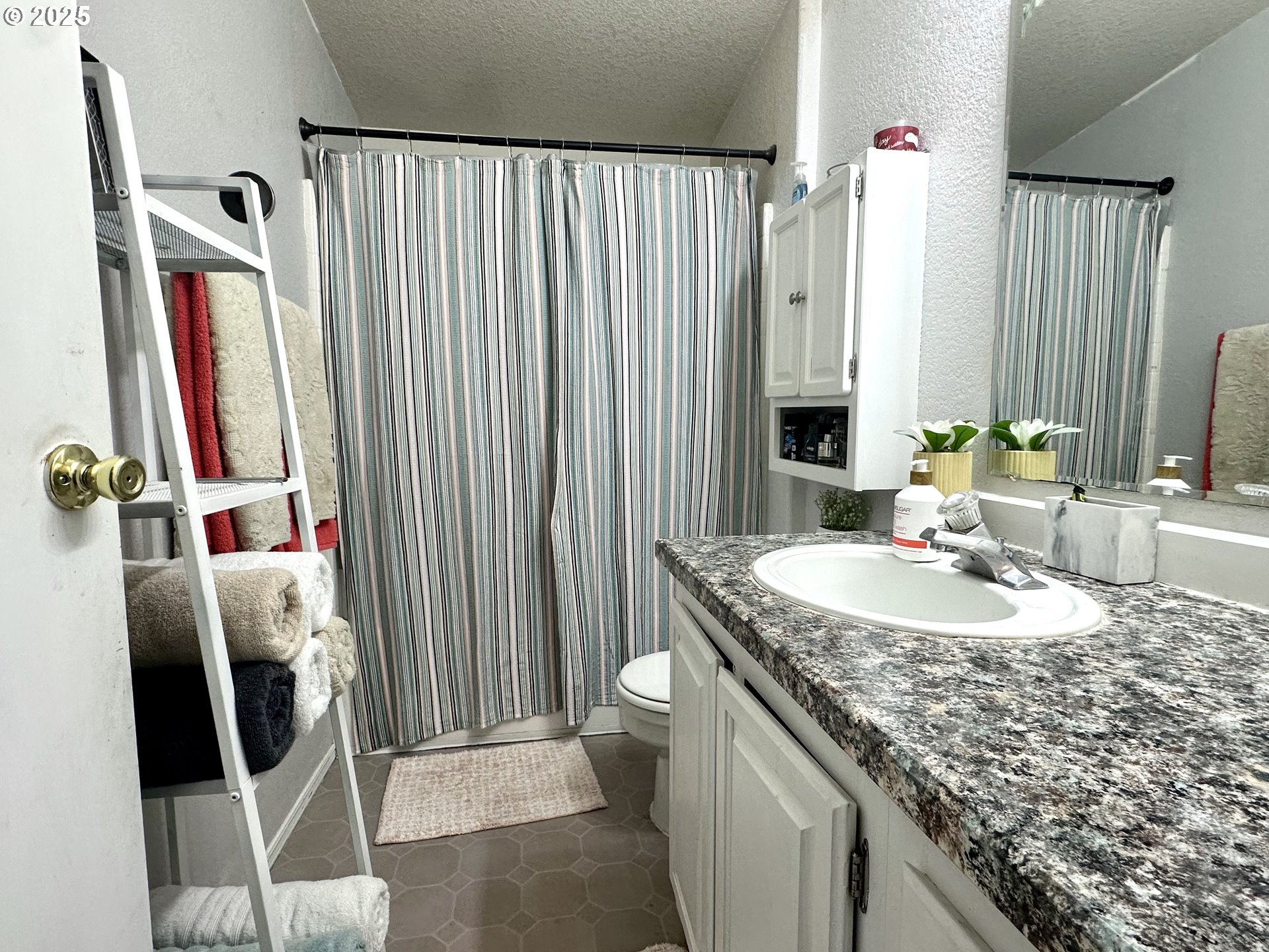5510 E Street Springfield, OR 97478 - Photo 8 of 21 a bathroom with a granite countertop sink and a mirror