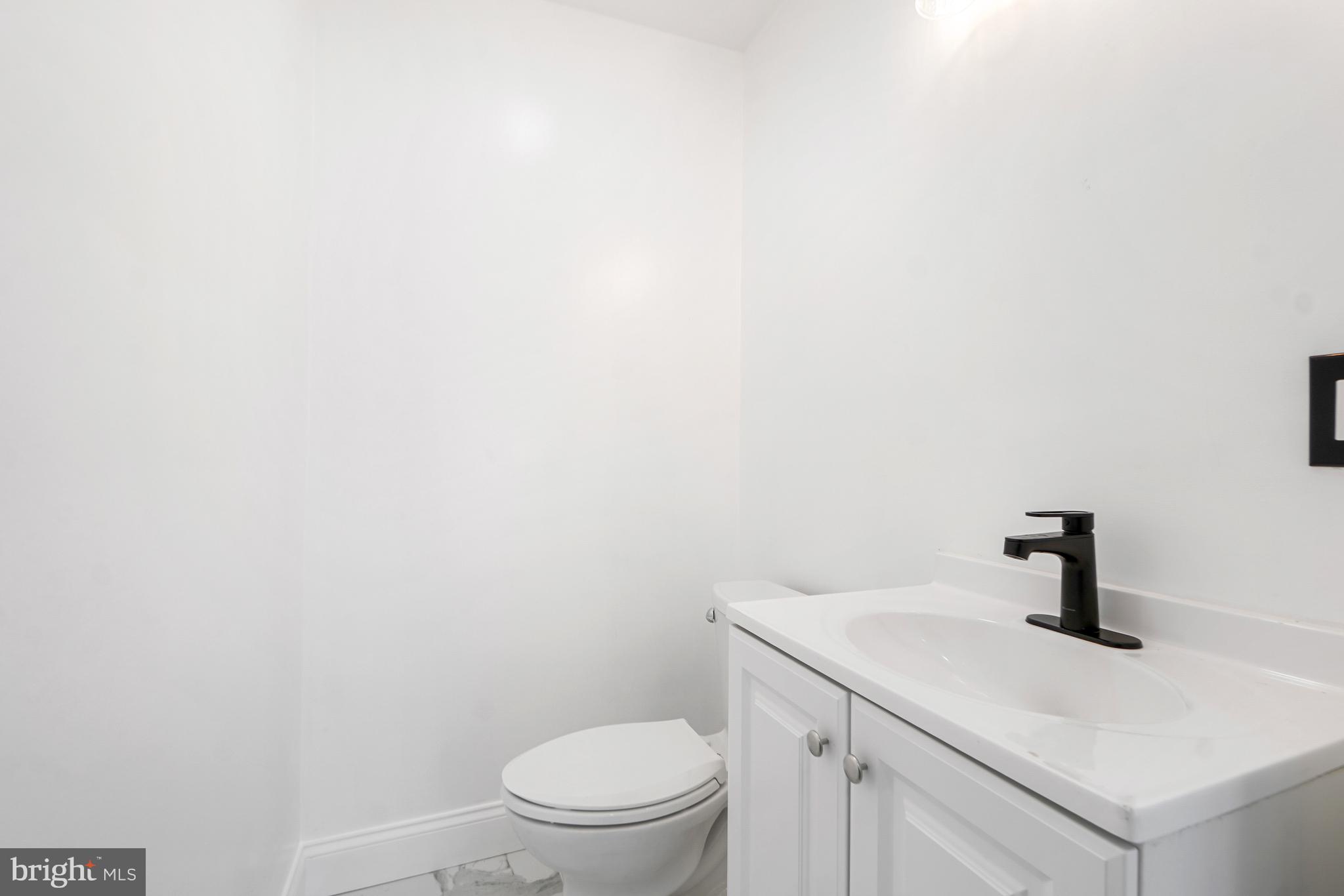 5309 Chesapeake Road Hyattsville, MD 20781 - Photo 11 of 36 a bathroom with a toilet sink and vanity