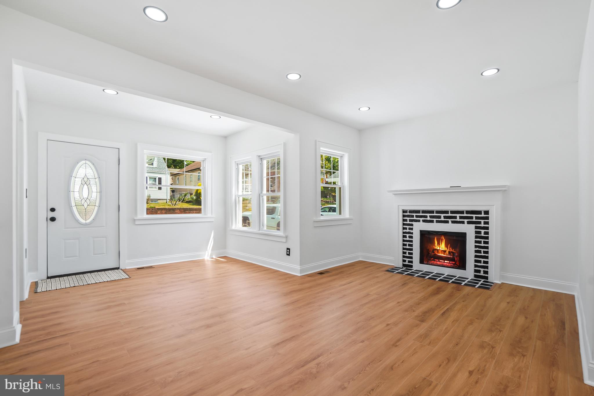 5309 Chesapeake Road Hyattsville, MD 20781 - Photo 12 of 36 an empty room with windows and fireplace