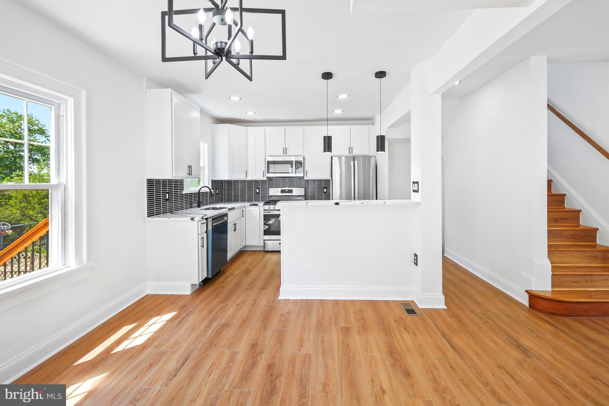 5309 Chesapeake Road Hyattsville, MD 20781 - Photo 13 of 36 a view of a kitchen with wooden floor and electronic appliances