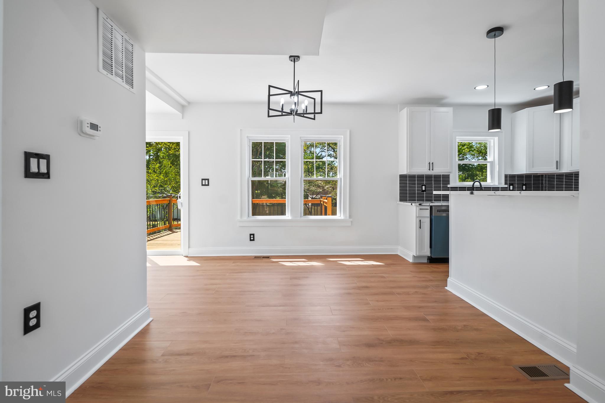 5309 Chesapeake Road Hyattsville, MD 20781 - Photo 18 of 36 a view of an empty room with window wooden floor and kitchen view