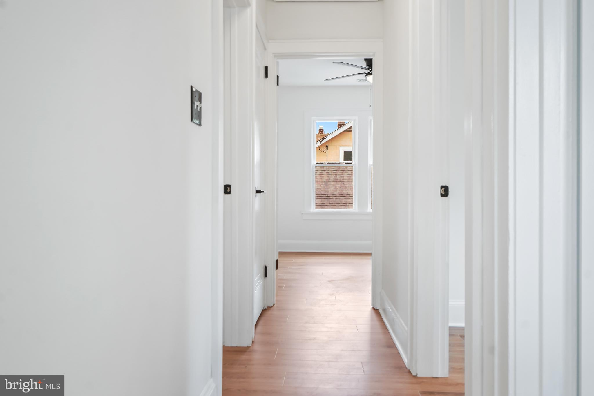 5309 Chesapeake Road Hyattsville, MD 20781 - Photo 20 of 36 a view of a hallway with wooden floor and a bathroom