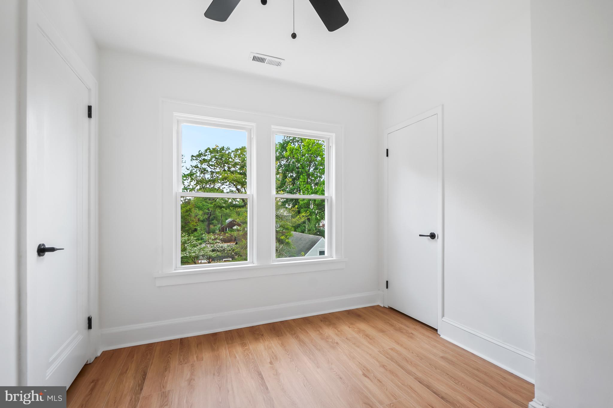 5309 Chesapeake Road Hyattsville, MD 20781 - Photo 21 of 36 a view of an empty room with wooden floor and a window