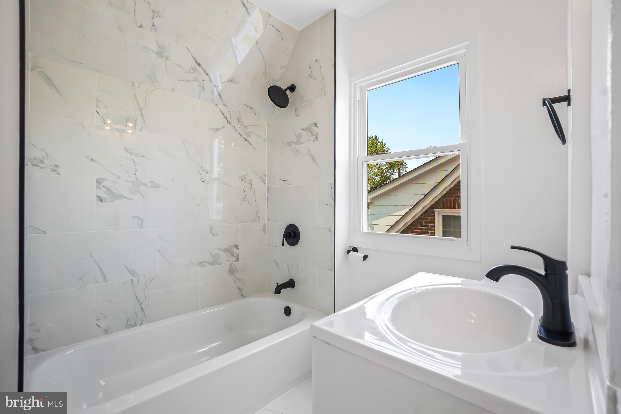 5309 Chesapeake Road Hyattsville, MD 20781 - Photo 22 of 36 a bathroom with a bathtub a shower and a sink