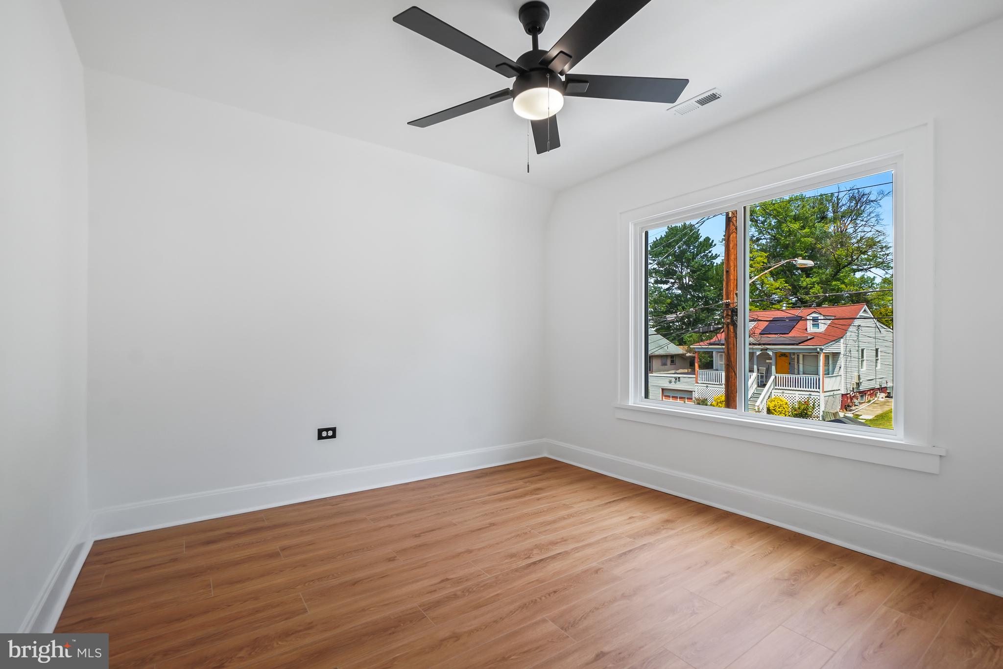5309 Chesapeake Road Hyattsville, MD 20781 - Photo 24 of 36 an empty room with wooden floor fan and windows