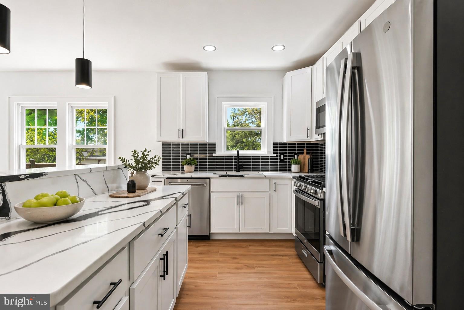 5309 Chesapeake Road Hyattsville, MD 20781 - Photo 3 of 36 a kitchen with a refrigerator sink and white cabinets