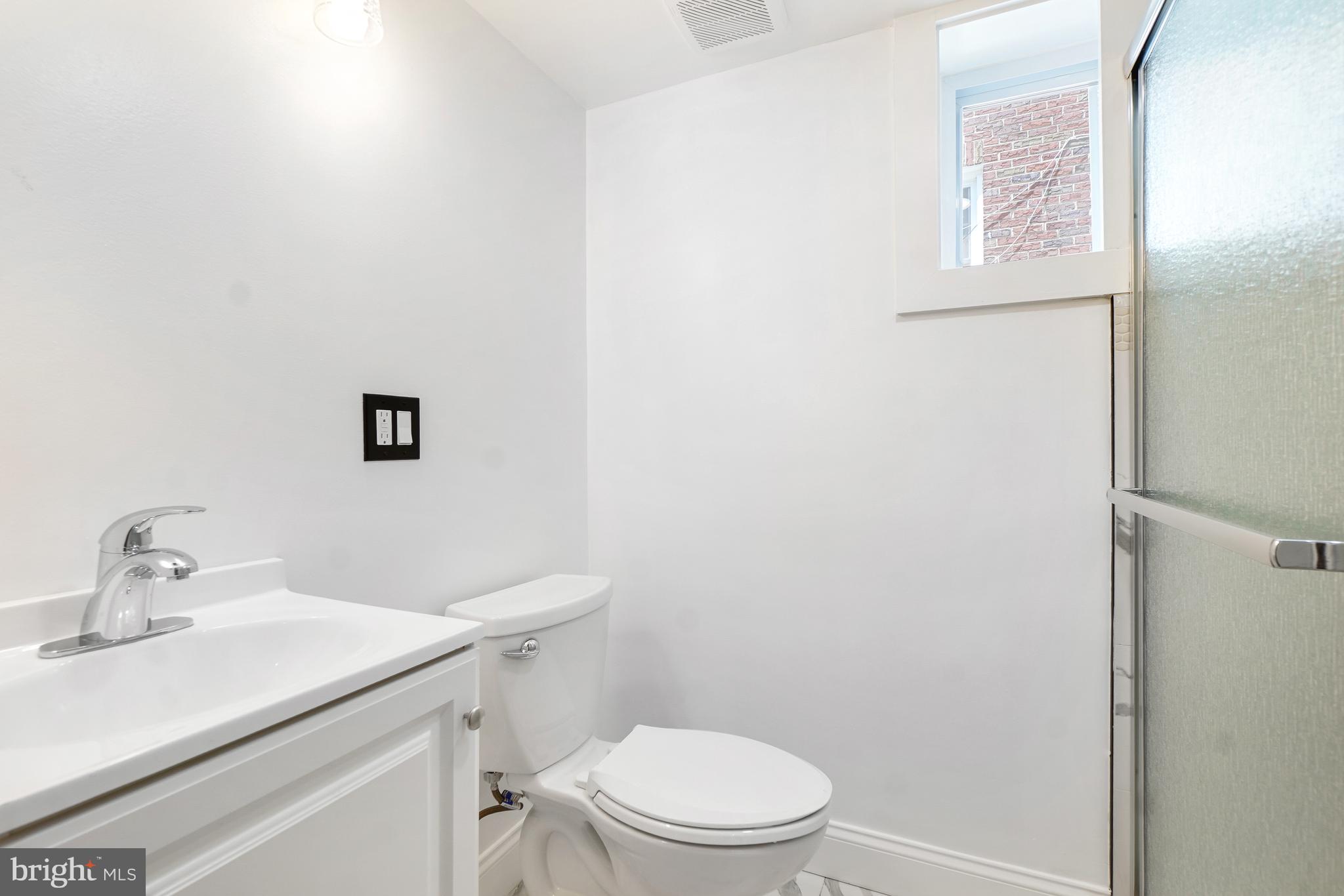 5309 Chesapeake Road Hyattsville, MD 20781 - Photo 31 of 36 a bathroom with a sink a toilet and mirror