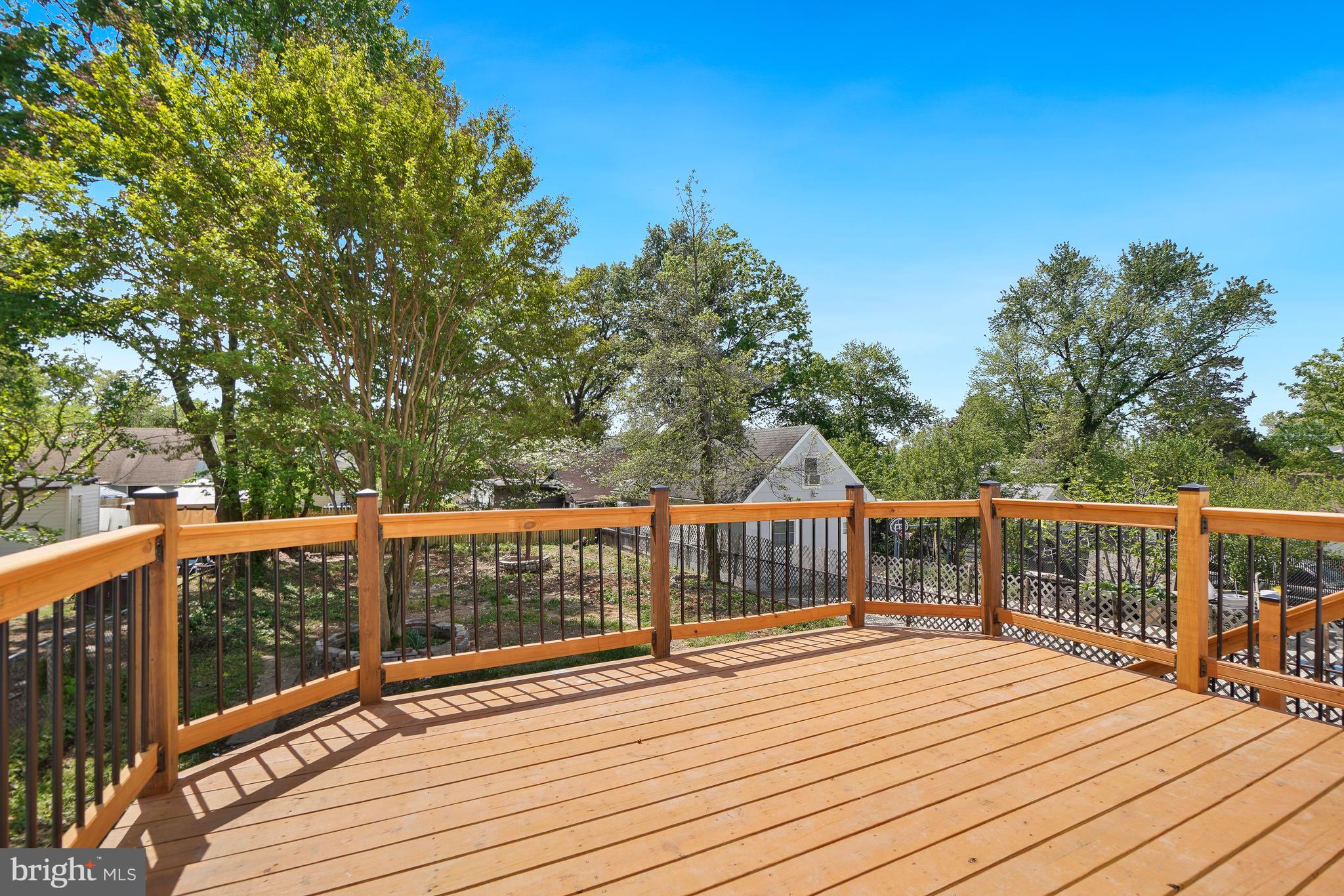 5309 Chesapeake Road Hyattsville, MD 20781 - Photo 35 of 36 a view of deck with wooden floor and fence with large trees