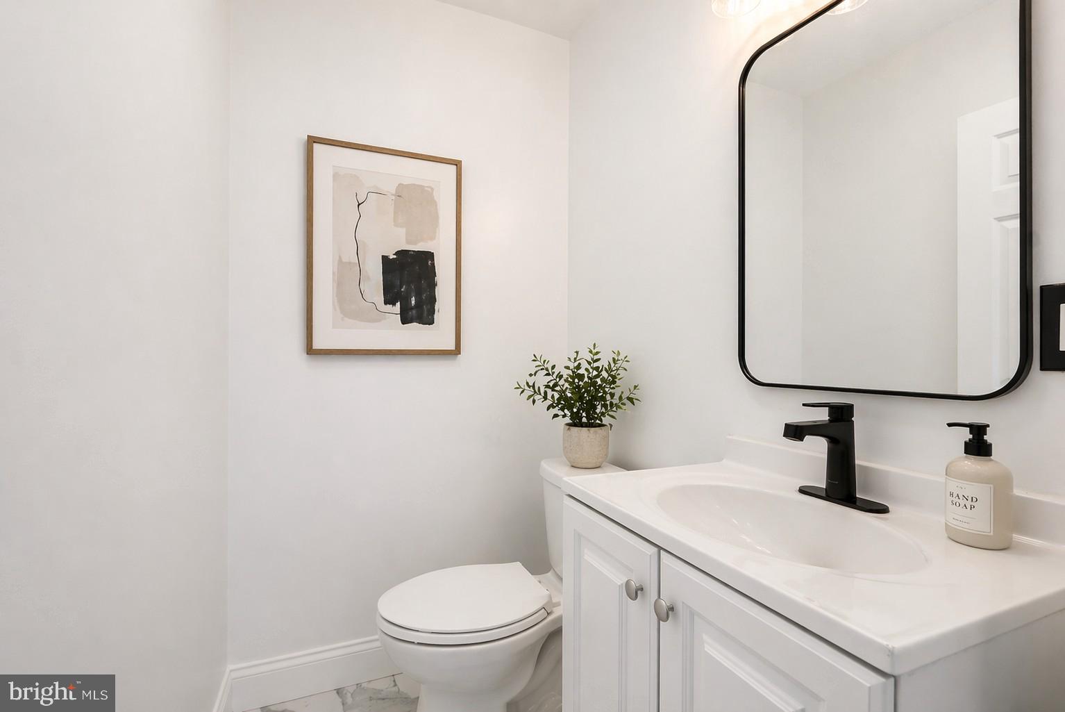 5309 Chesapeake Road Hyattsville, MD 20781 - Photo 4 of 36 a bathroom with a toilet sink and mirror