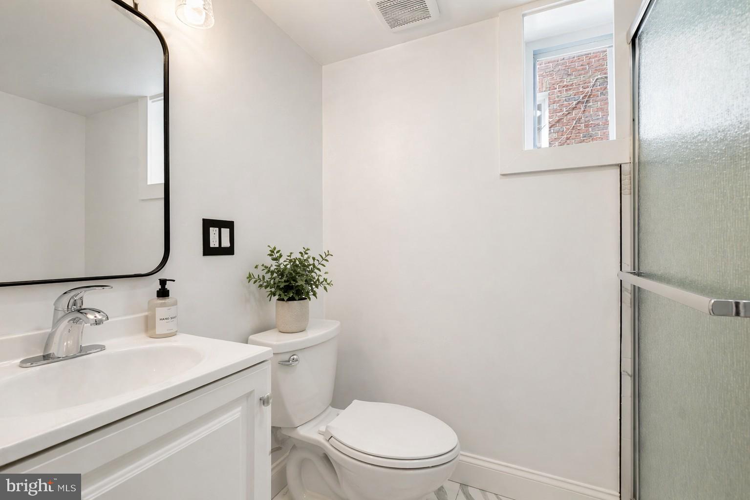 5309 Chesapeake Road Hyattsville, MD 20781 - Photo 6 of 36 a bathroom with a sink mirror vanity and toilet