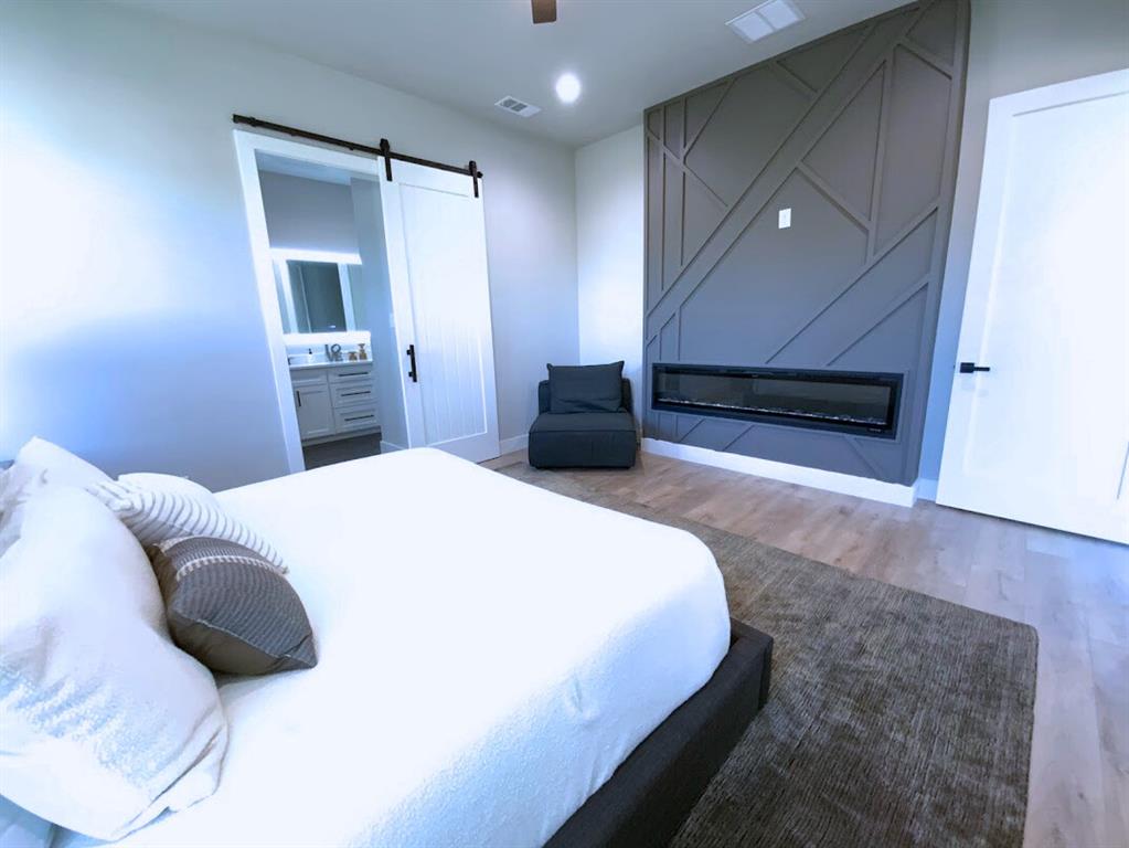 2770 Moffatt Avenue Dallas, TX 75216 - Photo 10 of 25 a bedroom with a bed and a television