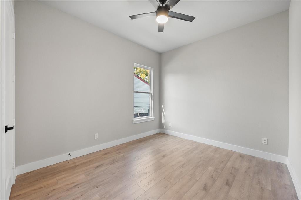 2770 Moffatt Avenue Dallas, TX 75216 - Photo 16 of 25 wooden floor in an empty room with a window