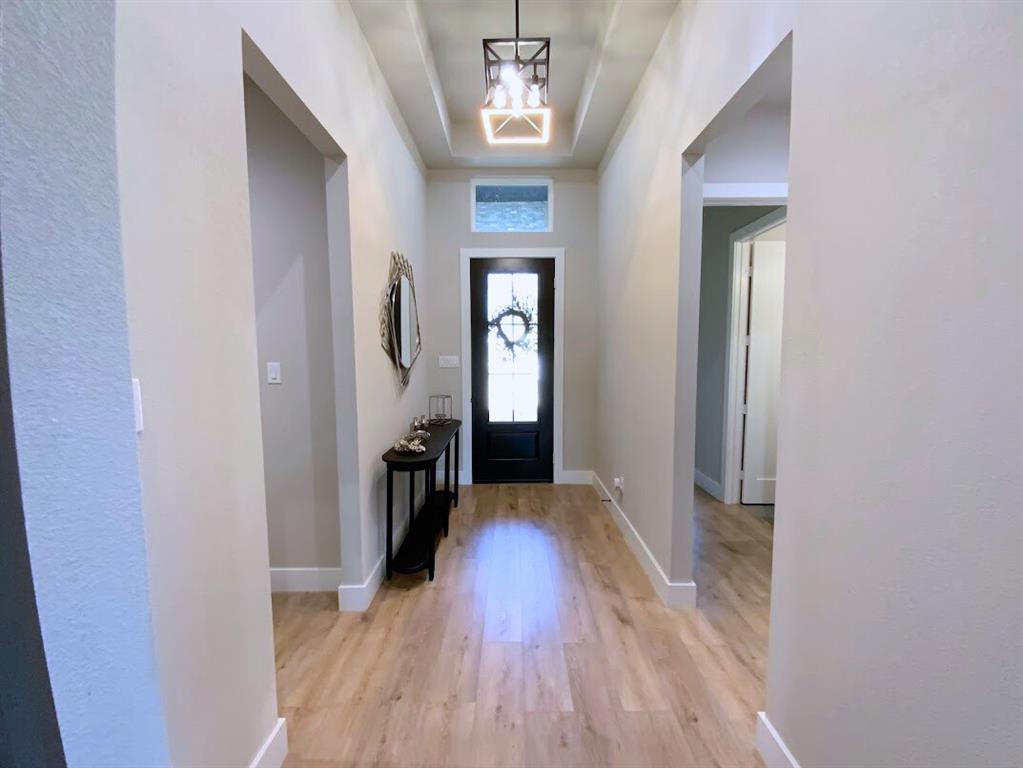 2770 Moffatt Avenue Dallas, TX 75216 - Photo 2 of 25 a view of a hallway with wooden floor and a hallway