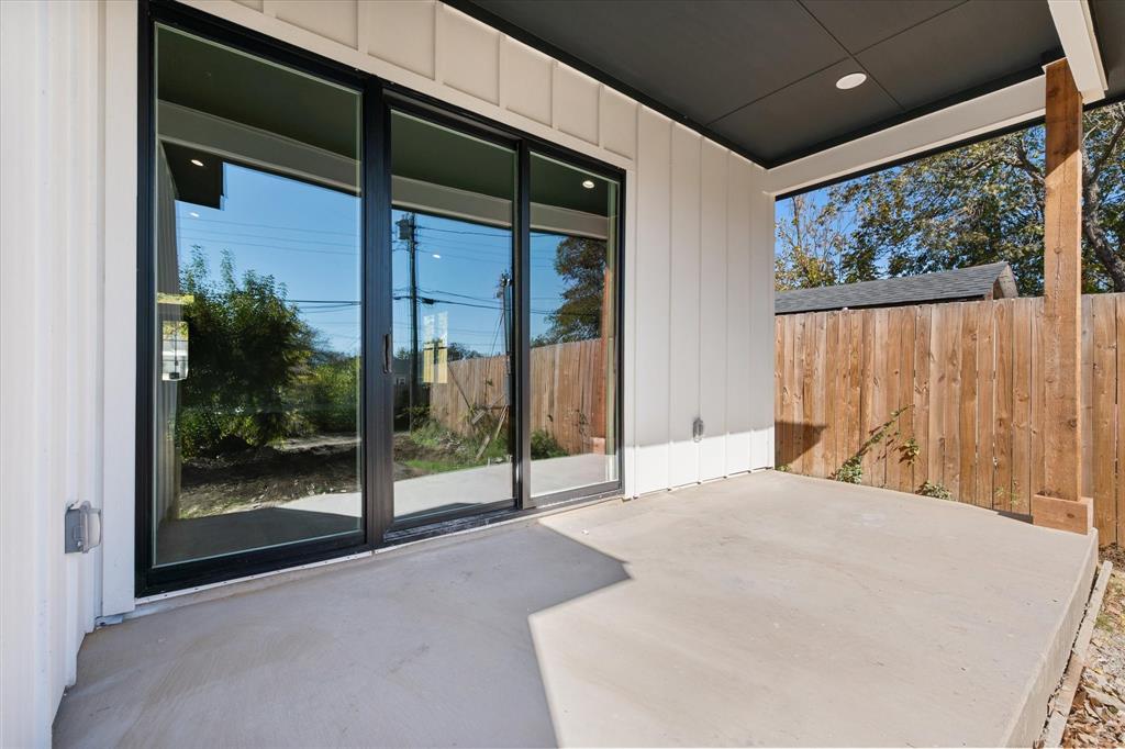 2770 Moffatt Avenue Dallas, TX 75216 - Photo 22 of 25 a bedroom with a large bed and a large window