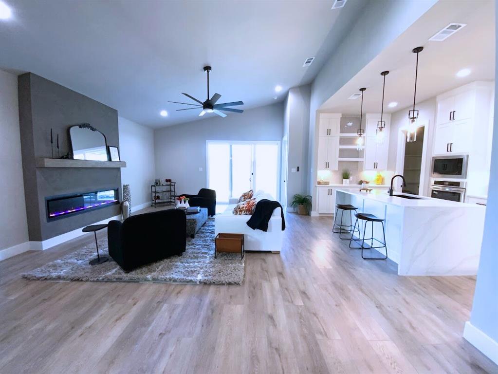 2770 Moffatt Avenue Dallas, TX 75216 - Photo 25 of 25 a living room with furniture kitchen view and a wooden floor