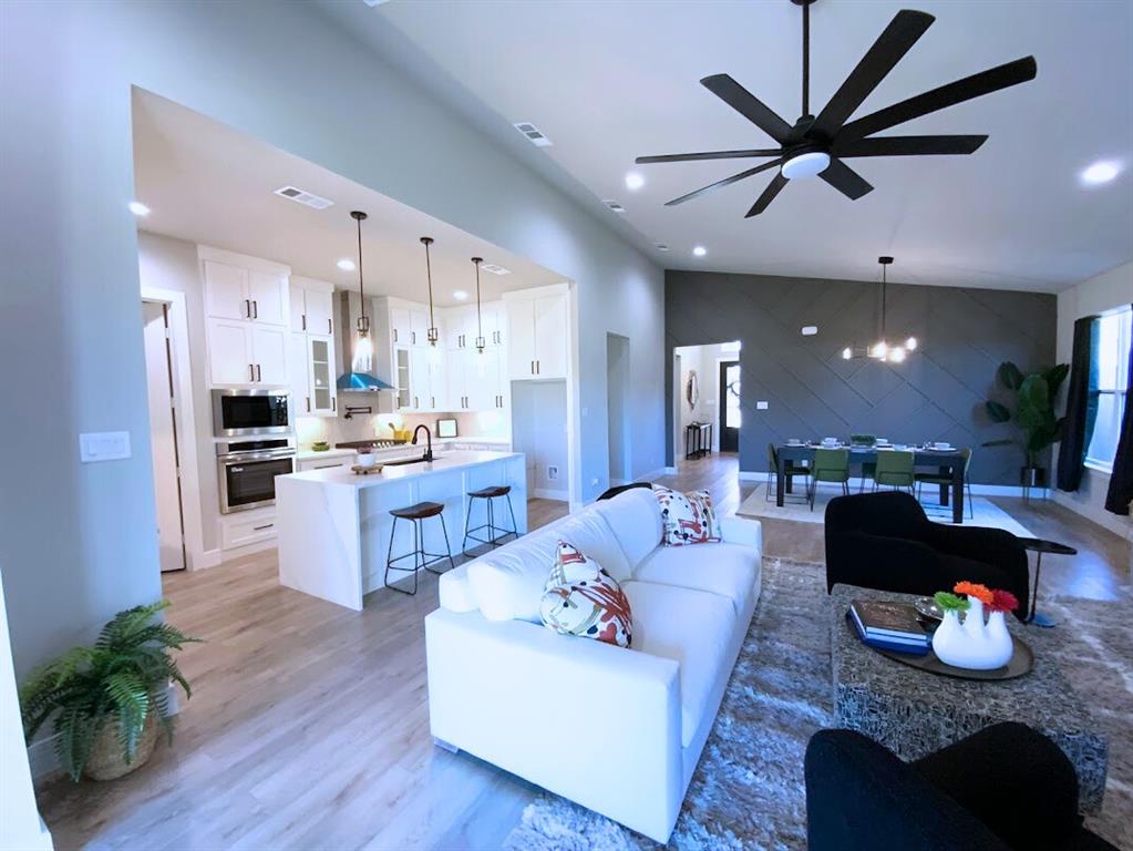 2770 Moffatt Avenue Dallas, TX 75216 - Photo 3 of 25 a living room with furniture kitchen view and a wooden floor