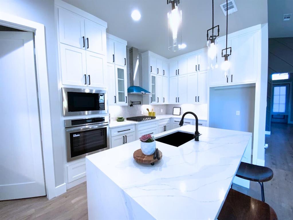 2770 Moffatt Avenue Dallas, TX 75216 - Photo 6 of 25 a kitchen with stainless steel appliances a stove a sink a refrigerator and cabinets