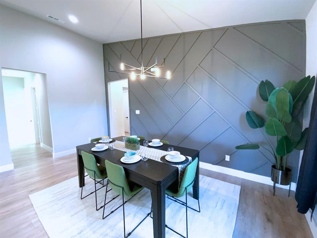 2770 Moffatt Avenue Dallas, TX 75216 - Photo 8 of 25 a view of a dining room with furniture and wooden floor
