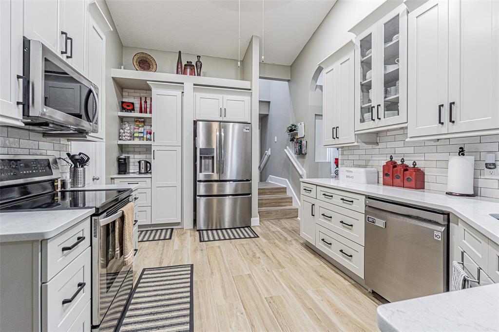 9809 La Rita Place Riverview, FL 33569 - Photo 5 of 59 a kitchen with stainless steel appliances a stove refrigerator and a microwave