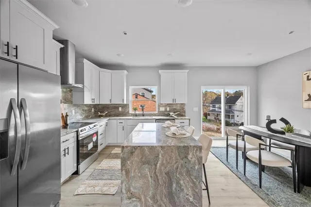 a kitchen with granite countertop lots of counter top space and stainless steel appliances