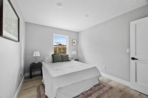 a bedroom with a bed and a lamp