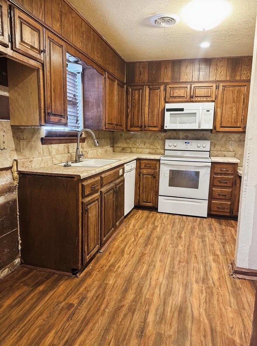 7811 Highway 86 Tulia, TX 79088 - Photo 11 of 19 a kitchen with stainless steel appliances granite countertop a stove a sink dishwasher and a refrigerator