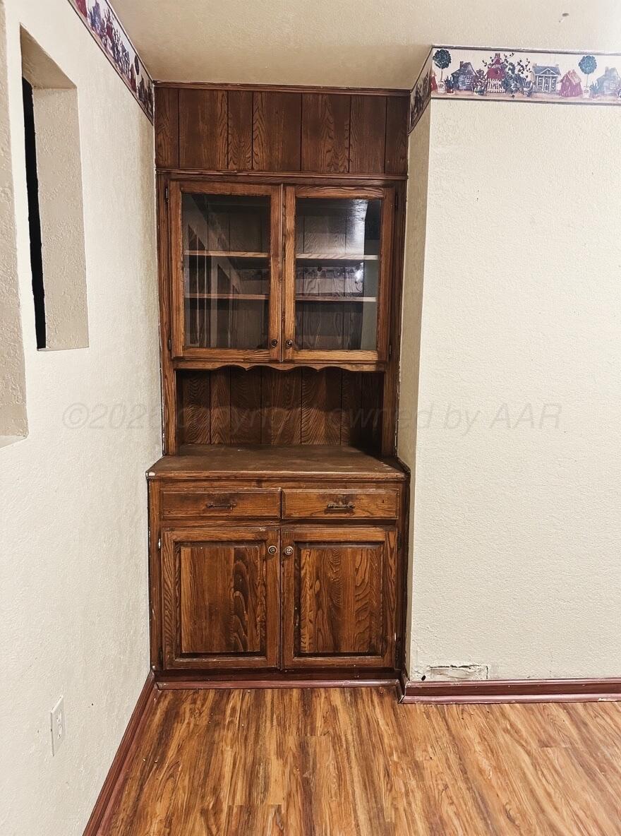 7811 Highway 86 Tulia, TX 79088 - Photo 12 of 19 a view of kitchen with wooden floor and cabinets
