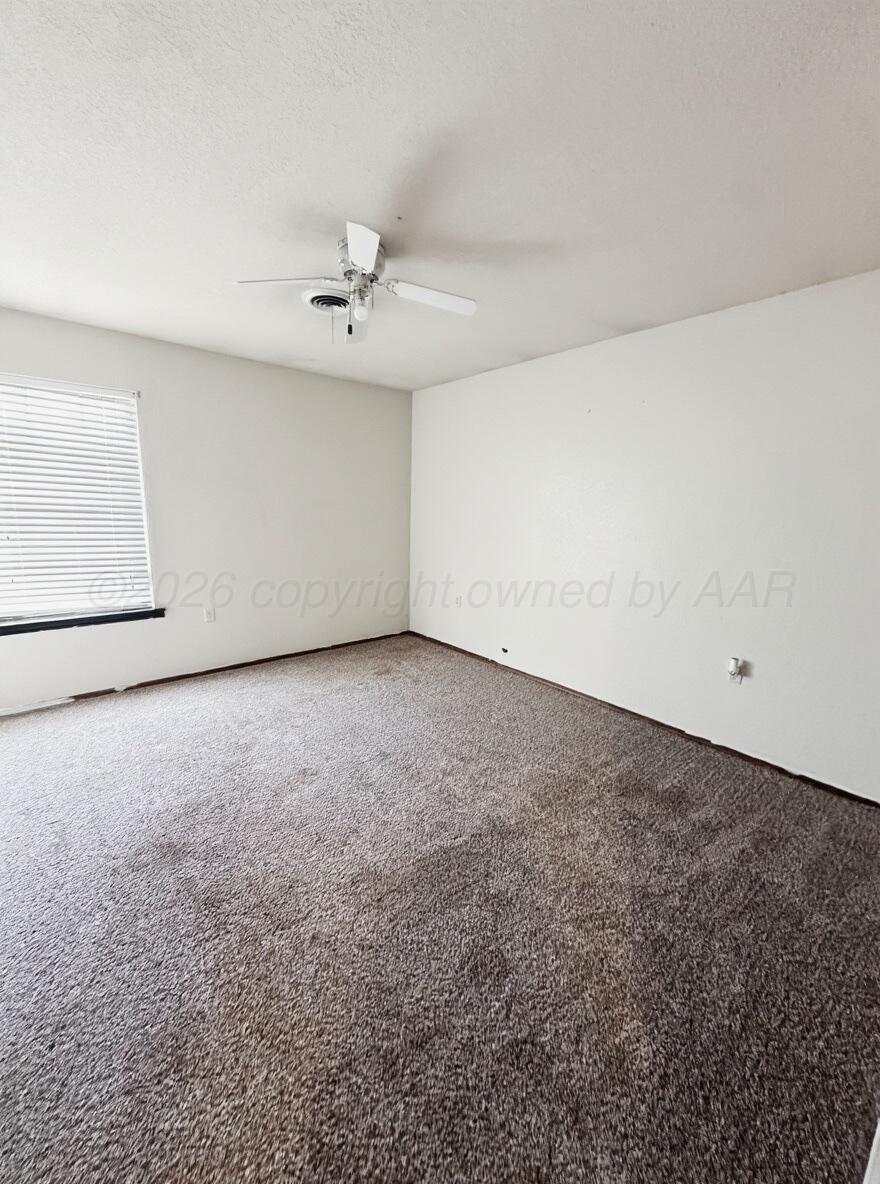 7811 Highway 86 Tulia, TX 79088 - Photo 16 of 19 an empty room with a ceiling fan and a window