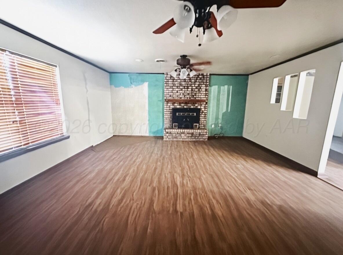 7811 Highway 86 Tulia, TX 79088 - Photo 7 of 19 a view of empty room with wooden floor and fan