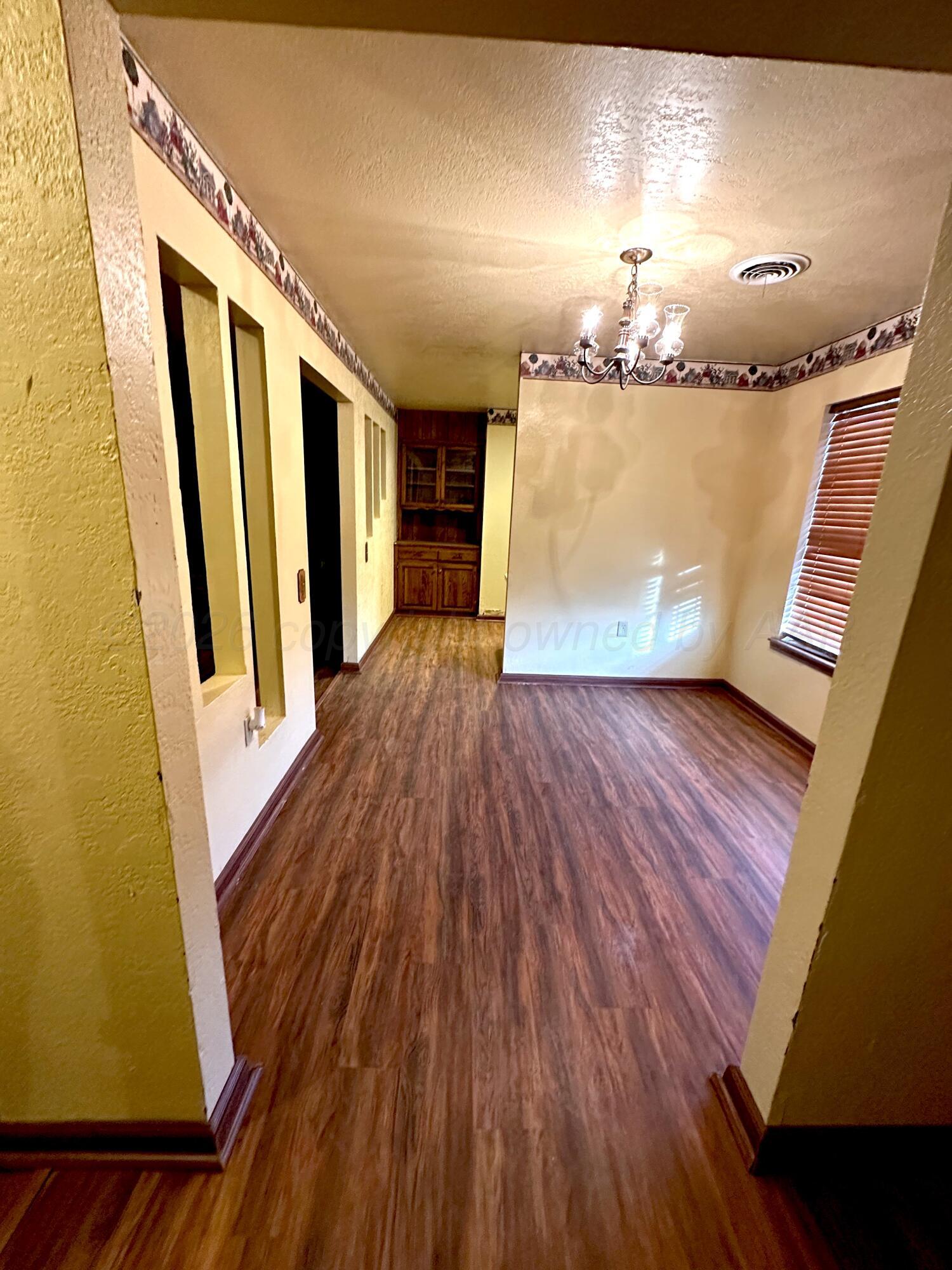 7811 Highway 86 Tulia, TX 79088 - Photo 8 of 19 a view of a room with wooden floor and stairs