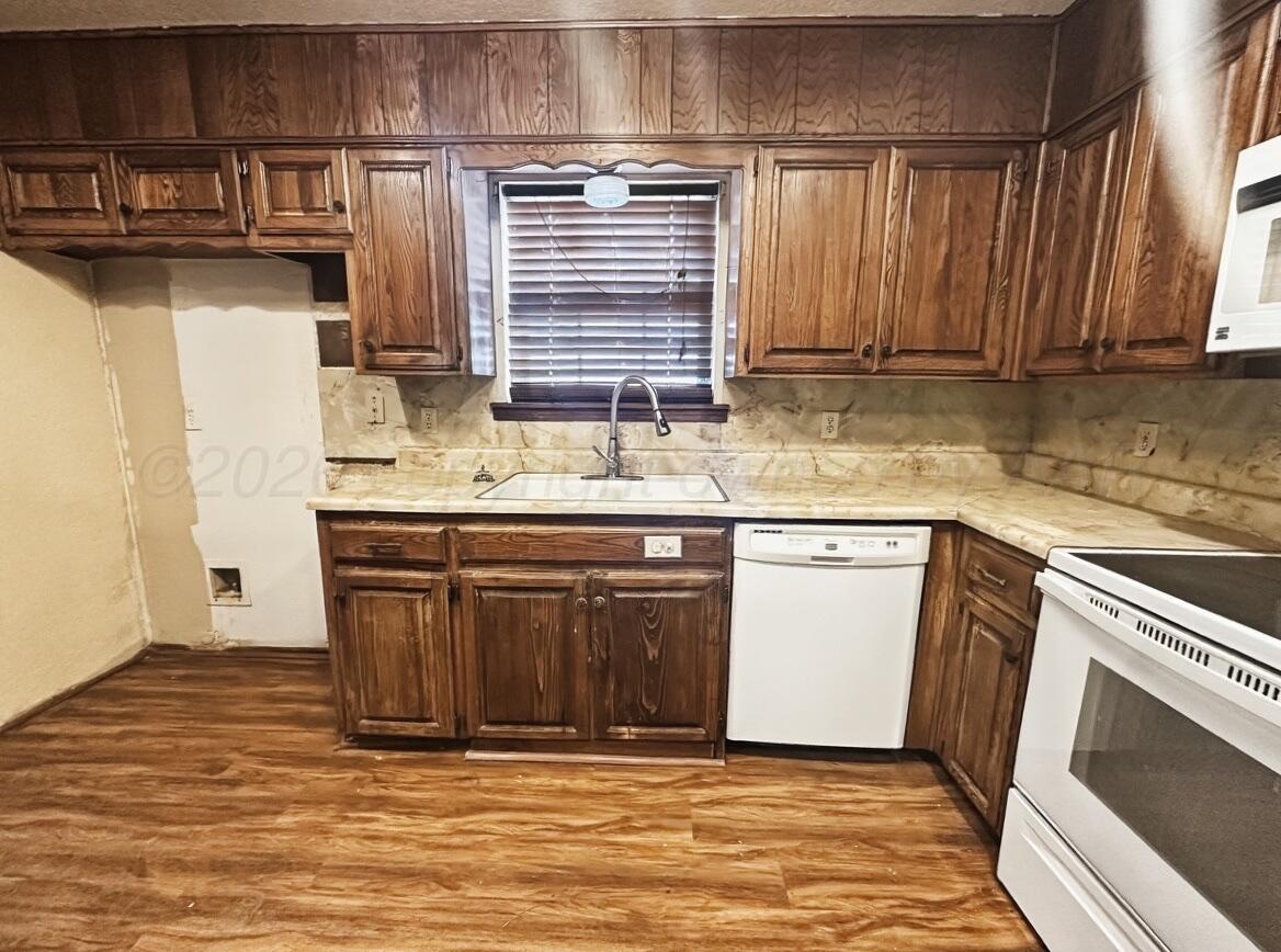 7811 Highway 86 Tulia, TX 79088 - Photo 10 of 19 a kitchen with stainless steel appliances granite countertop a sink stove and cabinets