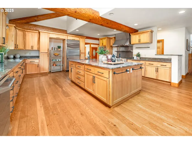 a kitchen with stainless steel appliances granite countertop sink stove and large window