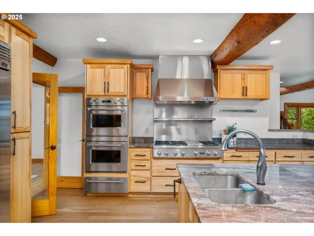 a open kitchen with stainless steel appliances granite countertop a stove and cabinets