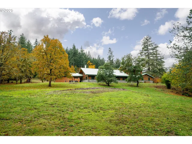 an aerial view of a house with garden space and street view